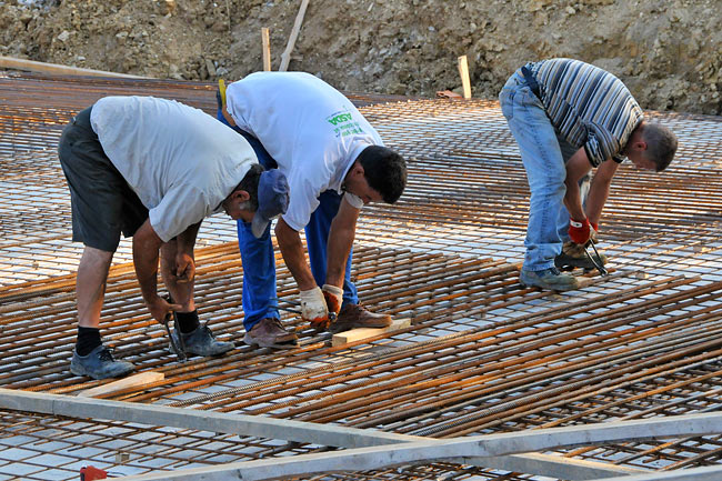 Fastening the iron bars on top of the first layer of iron mesh - 1