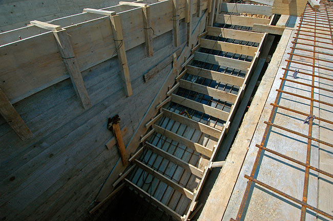 Cast of the stairs with the iron reinforcement and wooden planks for casting each step
