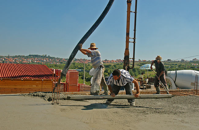 Pouring concrete progression: pouring, spreading, equalizing