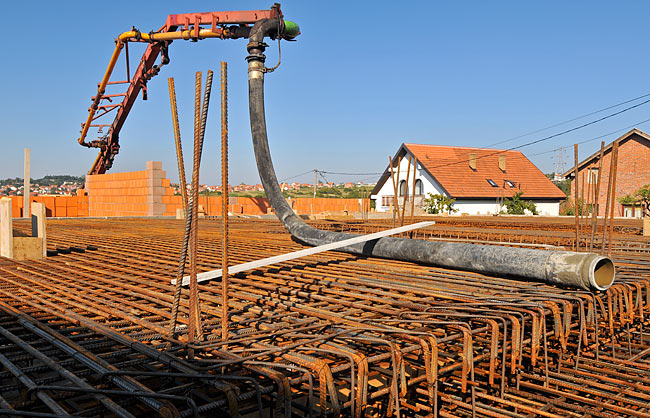 The hose of MARMIL inženjering's concrete pump, fully deployed on Amadeo A1, and hopping above Amadeo A2