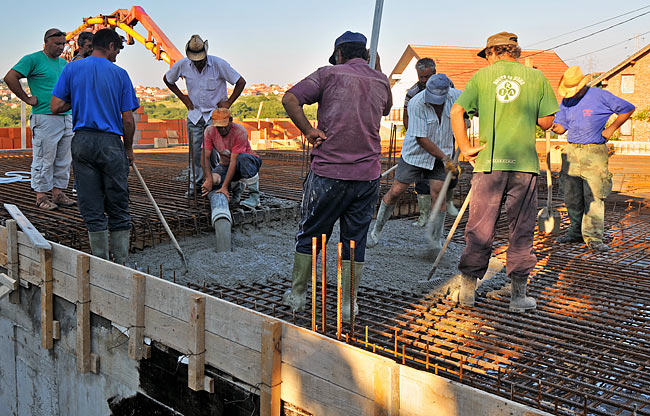 Starting pouring concrete from the furthest point the hose could reach