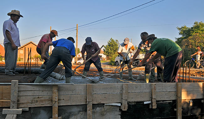 Spreading concrete toward the far end of the slab